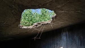 Close-up of a giant hole in a roof.