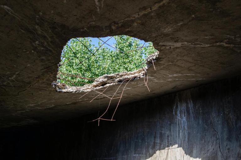 Close-up of a giant hole in a roof.