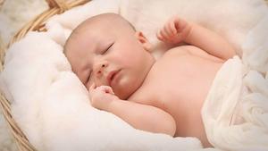 Sleeping baby in a basket.