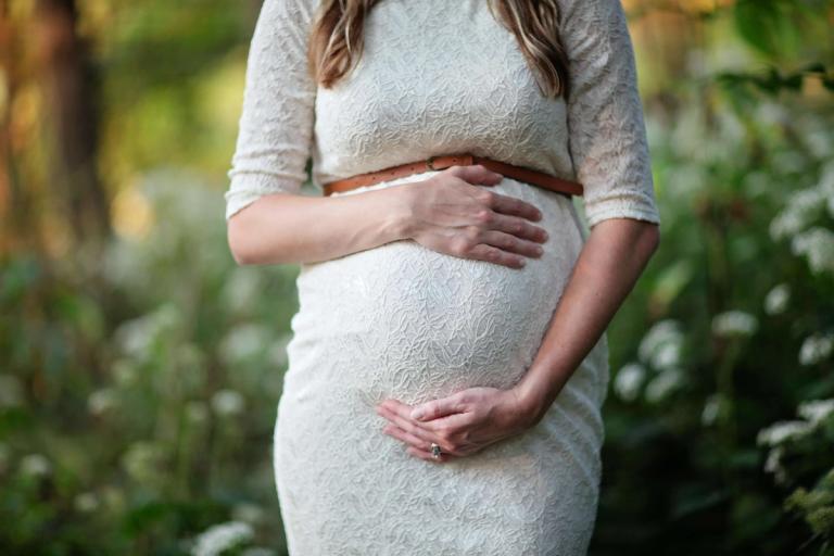 Pregnant woman caressing her stomach.