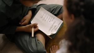 Two kids looking over a checklist.