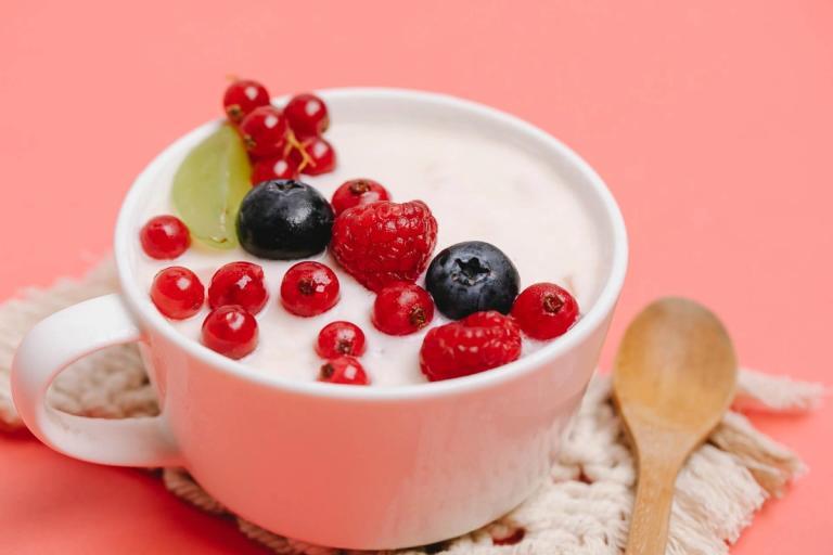 Yogurt with berries on top.