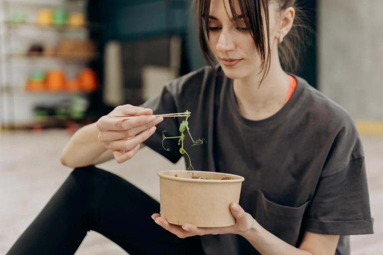 Woman eating a salad.