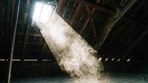 Attic window with sunlight beaming through.