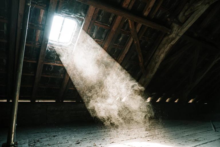 Attic window with sunlight beaming through.