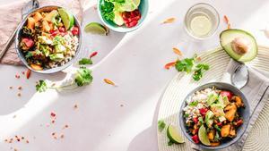 Top-down of colorful food in bowls.