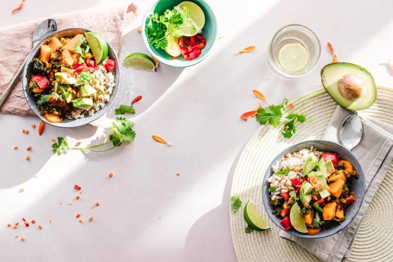 Top-down of colorful food in bowls.