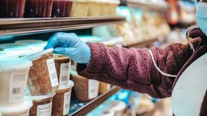 Woman carefully reading a food container.