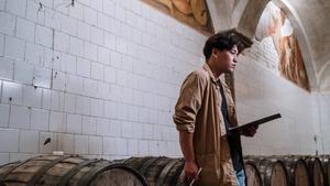 A man pondering over a checklist in a brewery.